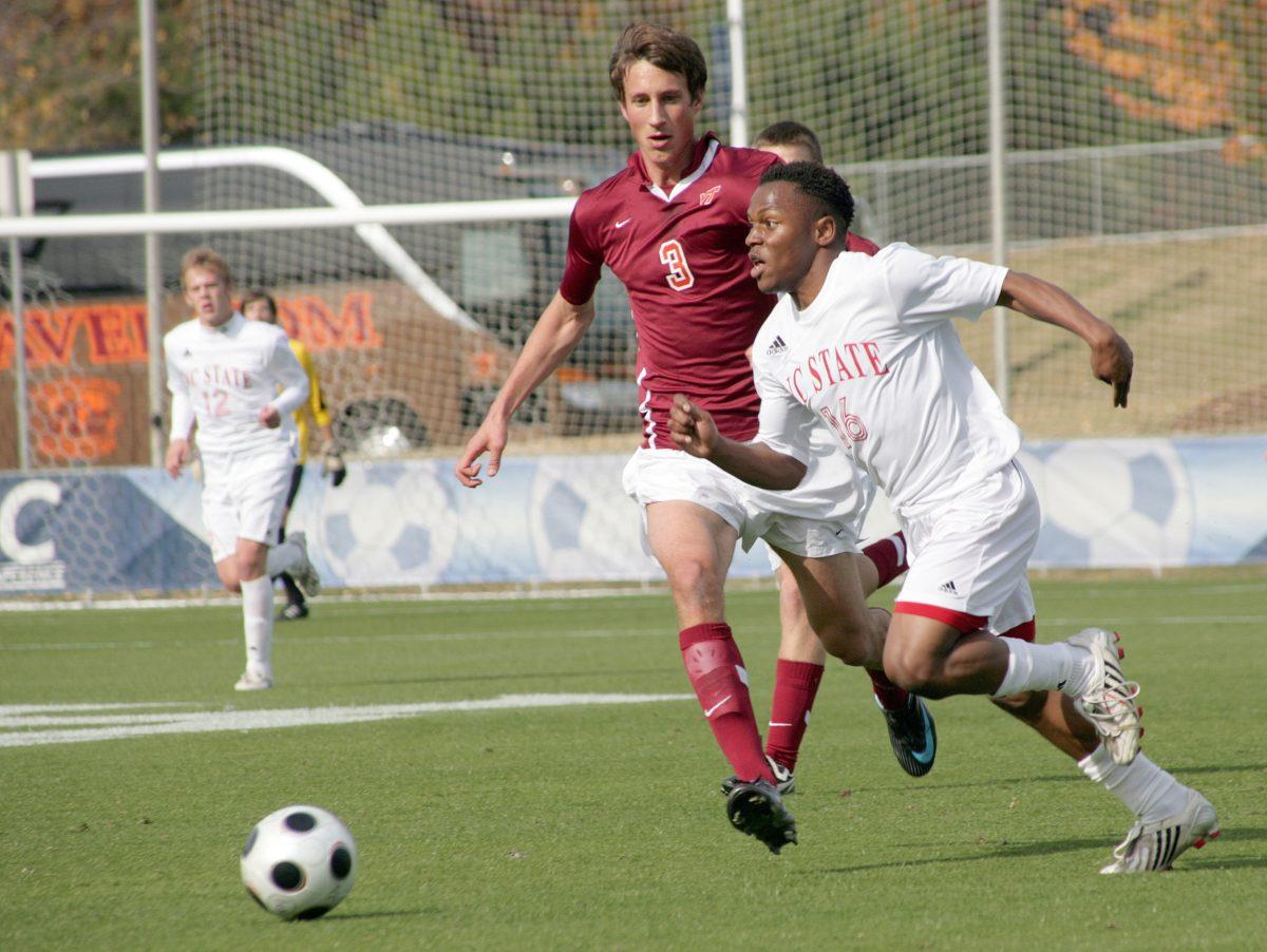 Junior midfielder Korede Aiyegbusi dribbles past Virginia Tech defender Tobias Hottner as the Pack cruised to a 3-1 victory
