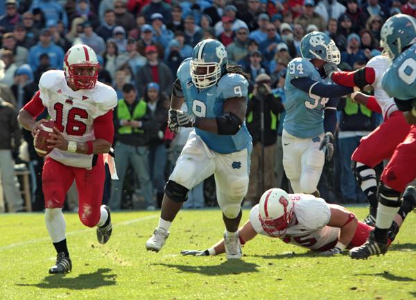 Quarterback Russell Wilson avoids pressure from North Carolina defensive end Marvin Ausitn. Wilson finished Saturday's showdown with UNC with 279 yards passing and two touchdowns. (Photo by Dreier Carr)