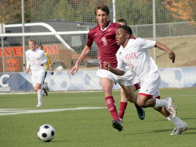 Junior midfielder Korede Aiyegbusi dribbles past Virginia Tech defender Tobias Hottner as the Pack cruised to a 3-1 victory