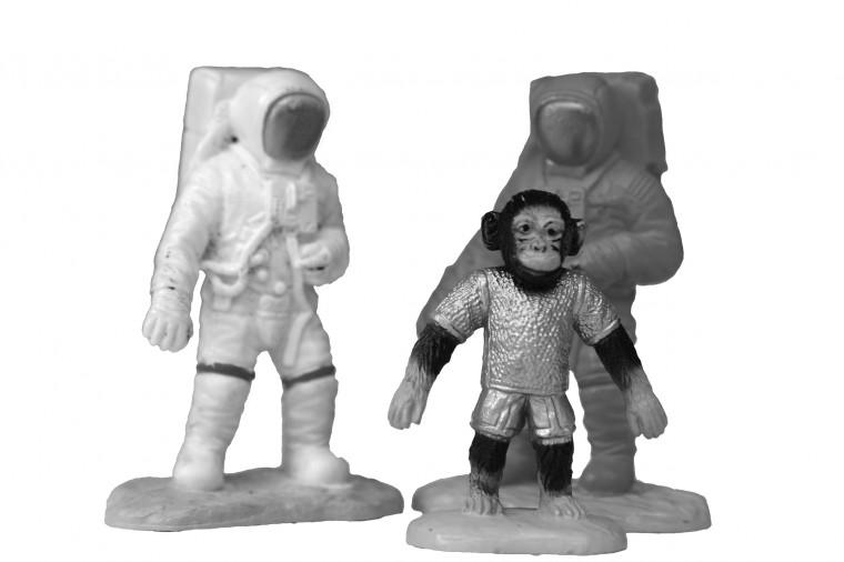 Two astronauts and Dirt the monkey pose for a photo. (Photo illustration by Craig Yates)