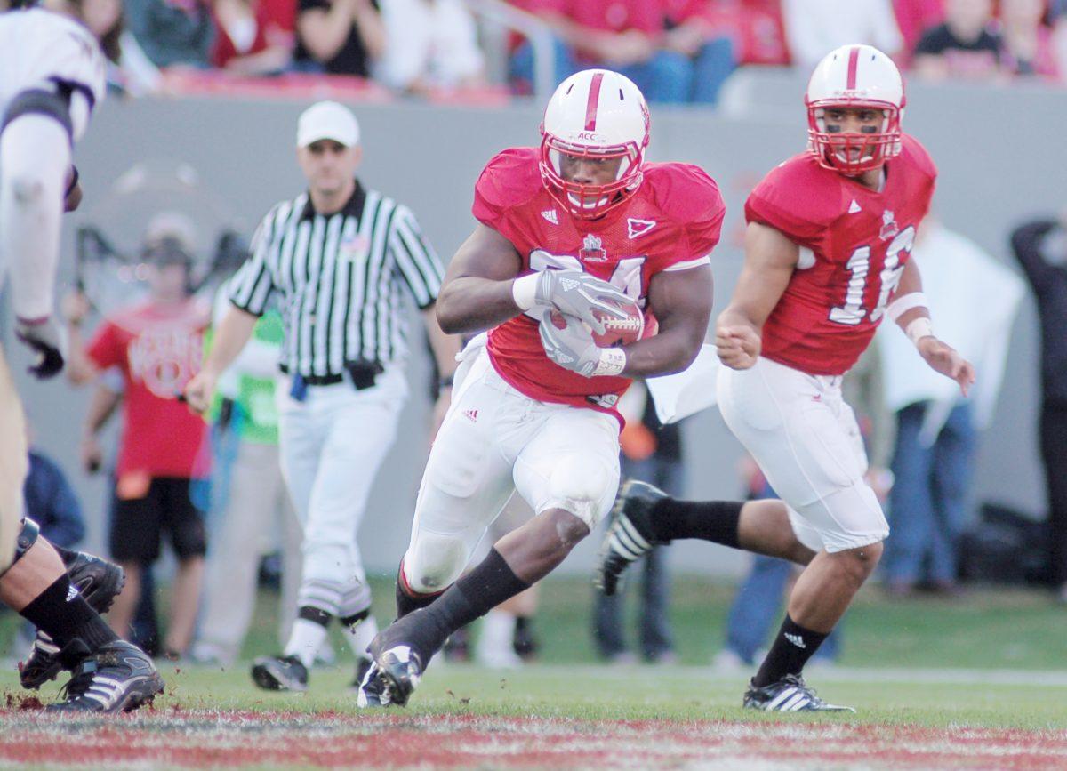 Redshirt freshman Russell Wilson hands the ball to senior halfback Andre Brown Nov. 15