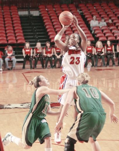 Senior gaurd Shayla Fields shoots over two Charlotte players in Sunday's game. Fields was named MVP for the Wolfpack Invitational game. She scored 33 points and had 3 assists against Charlotte.