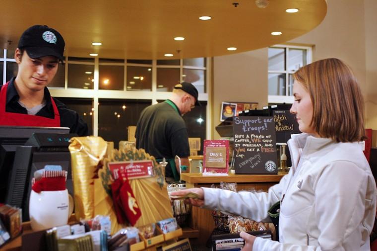 Alecia Murray, sophomore in communication, hands Andrew Radmacher, a student in Lifelong education, money to pay for her white chocolate mocha.