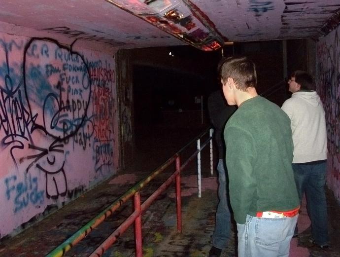 David Prescott, freshman in aerospace engineering, Donald Mayo, a freshman in mechanical engineering, and Ahren Lieth, a freshman in aerospace engineering, look at the graffiti that was put on the Free Expression Tunnel after the N.C. State and North Carolina basketball game Saturday afternoon. Photo by James Cox