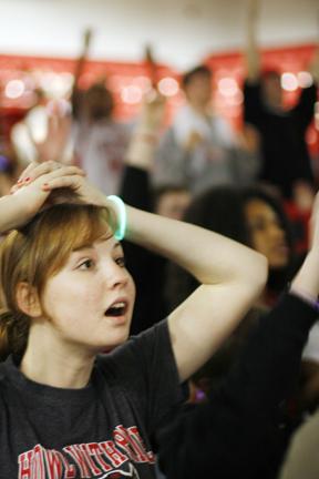Hannah Troutman, a freshman in fashion and textile management, watches the Wolfpack vs University of North Carolina basketball game at the Big Event viewing party in Renolds Coliseum Wednesday. "I was surprised by how many people came," Troutman said. Her favorite part was "just the school spirit." Photo by Tim O'Brien