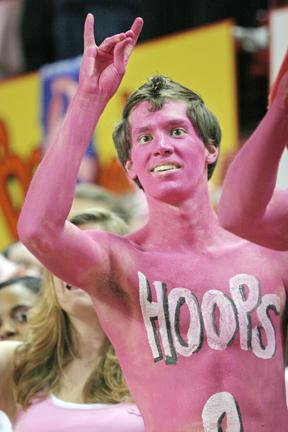 After N.C. State's victory against Boston College, then senior Scott Curcio gives the Wolfpack sign while late women's basketball coach Kay Yow addresses the crowd. Curcio went to the game to "support the Wolfpack and Hoops 4 Hope." Photo by Matt Moore