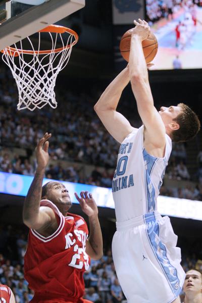 North Carolina's Tyler Hansborough goes up for a layup over Tracy Smith, a sophomore forward, in the second half of Wednesday night's game at the Dean E. Smith Center. Smith had 1 block and 2 defensive rebounds in 31 minutes of play in the Wolfpack's 89-80 loss to the Tar Heels. Photo by Brent Kitchen