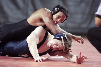 Darius Little works to half nelson Joe Baker of the Naval Academy. The Wolfpack took fifth place in the ACC meet, with Darrion Caldwell and Kody Hamrah winning individual championships.