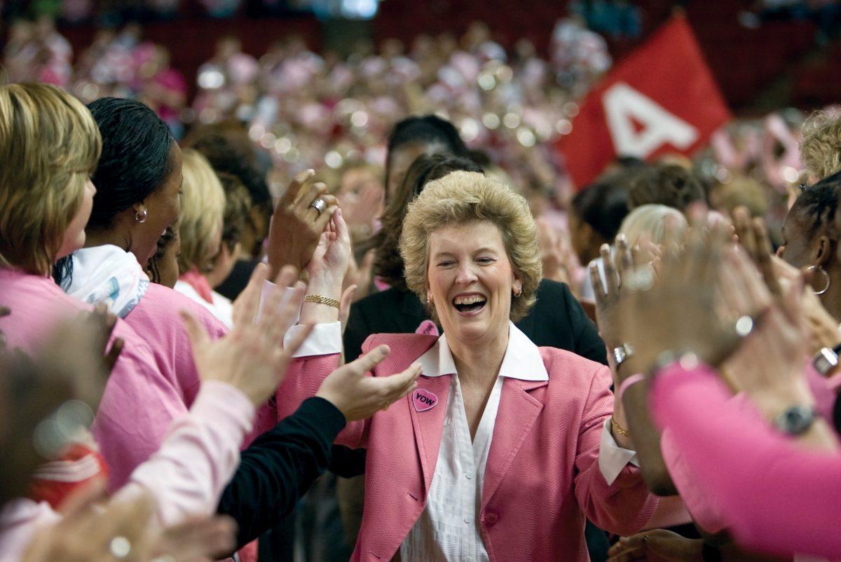 Interim head coach Stephanie Glance walks through a tunnel of cancer survivors onto the court before the Hoops for Hope game vs. Virginia at Reynolds Coliseum on Feb. 15.