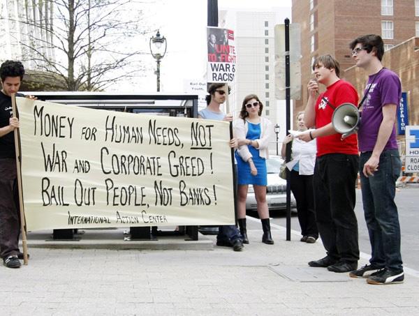 Ryan Thomson, a junior in political science, speaks with Scott Williams at the Bail Out the People Movement Protest in downtown Raleigh Friday April 3, 2009. Thomson is a member of the Students for Social Progress club on campus. "We're trying to freeze tuition and lower students interest rates," Thomson said. Photo by Tim O'Brien