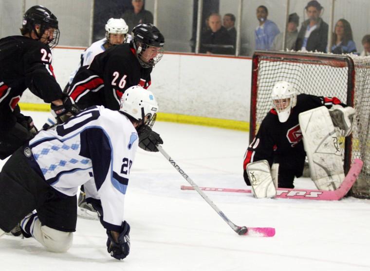 Stephen Russell guards the crease while freshman teammate Bryan MacLaren attemps to clear the puck Feb 2 against Carolina, which also served as Kay Yow Night. Russell passed away July 4. Photo by