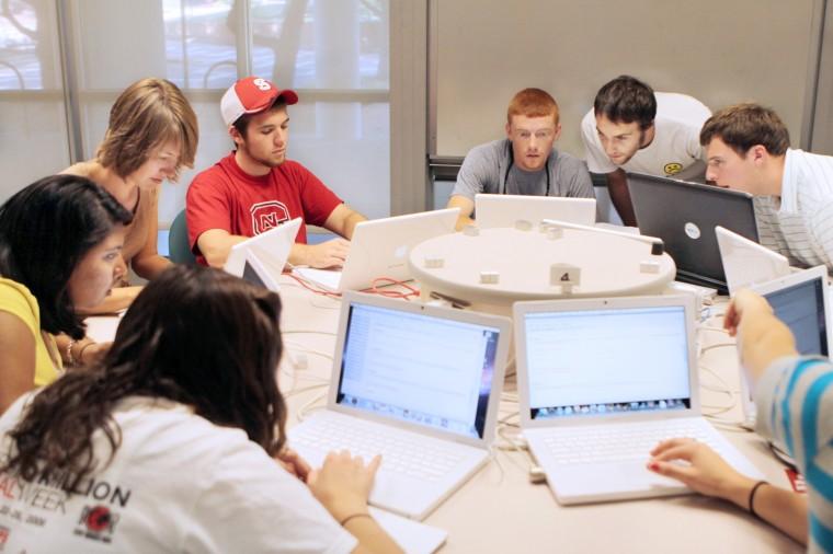 In the Maple help lab on the ground floor of Harrleson Hall, James Rohal, a doctoral student in the mathematics, helps Michael Nichelson, a freshman in first year college, Matthew Nifong, a sophomore in civil engineering, and Ben Claybrook, a sophomore in mechanical engineering, complete their assign- ments on Tuesday. &#8220;Learning code on top of mathematics, it really compounds the punishment,&#8221; Nichelson said. Photo by Jeffery Fowler