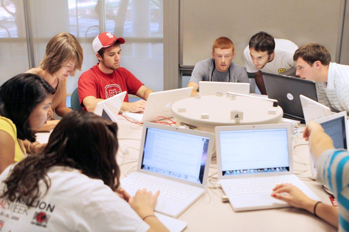 In the Maple help lab on the ground floor of Harrleson Hall, James Rohal, a doctoral student in the mathematics, helps Michael Nichelson, a freshman in first year college, Matthew Nifong, a sophomore in civil engineering, and Ben Claybrook, a sophomore in mechanical engineering, complete their assign- ments on Tuesday. &#8220;Learning code on top of mathematics, it really compounds the punishment,&#8221; Nichelson said. Photo by Jeffery Fowler