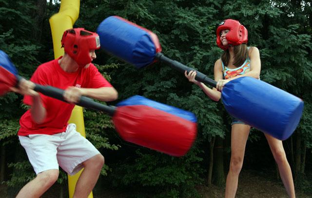Trying to knock each other down, Mac Buben, freshman in turfgrass management, and Kaitlin Bunn, freshman in biology, swing at each other with padded sticks. "I feel like he shouldn't have hit me so hard," Bunn said. Photo by David Mabe