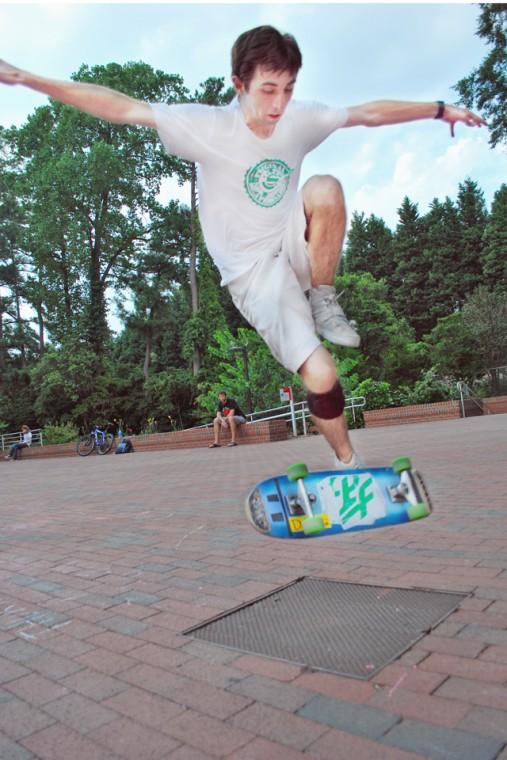 Sean Burke, a sophomore in fashion and textile management, performs a trick called an "impossible" in front of the Free Expression Tunnel on Wednesday. It took three months for Burke to learn this trick, but "dedication and practice yields success," he said. Sean is the event coordinator for the NCSU Skateboarding club. Photo by Jeffrey Fowler