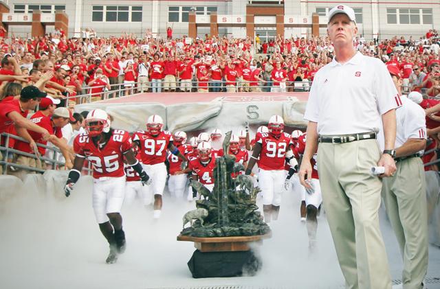 Head coach Tom O'Brien leads the 2007 men's football team onto to the field for the home opener against Central Florida. The Wolfpack fell, 25-23, to the UCF Knights. Photo by Josh Lawson