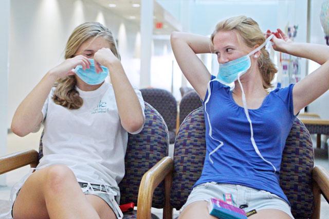 While H1N1 spreads significantly each day, more students are going to greater measures to protect themselves. Caitlyn Alberts, a freshman in First Year College, and Ellen Zeigler, a freshman in biology, wear masks while waiting to get checked out at the Student Health Center. "We are just wearing the masks for prevention so we don't pick up the virus," Alberts said. Many students requests masks when they walk in the center to lower their chances of catching the virus. Photo by Erica Heller