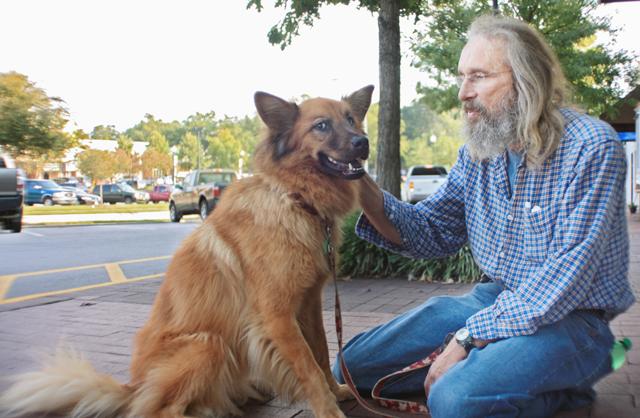 Doug Christian and his half Chow half German Shepard mix, Annie, walk around Cameron Village on Monday. When asked about the dog ban, the SPCA member said, "It's crazy, they are dog haters." The ban should be issued sometime in 2011. Photo by Ryann Pasquale