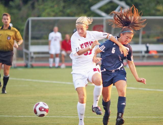 Kara Blosser, freshman in first year college, fends the ball from going out-of-bounds against Old Dominion Friday, Aug. 21, after assisting Paige Dugal, a sophomore in biomedical engineering, score the first goal in a winning effort. Photo by Jonathan Stephens