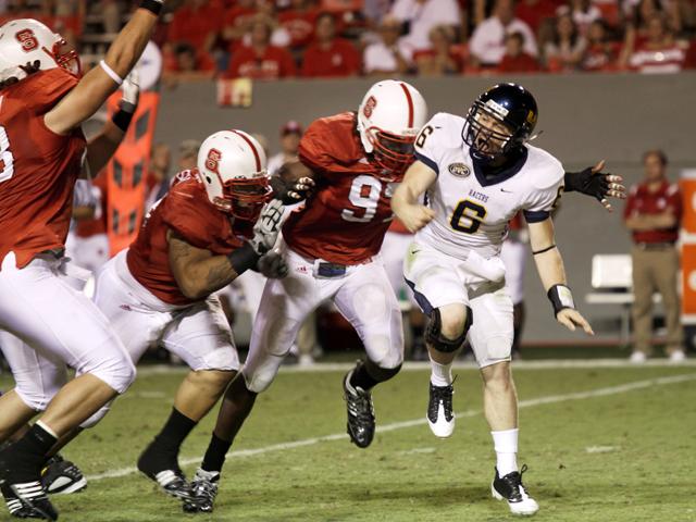 Redshirt graduate defensive end Willie Young lunges at Murray State quarterback Niko Yantko in an attempt to stop a pass. Young recorded two sacks for 14 yards and forced a fumble in a strong defensive showing by the Wolfpack Saturday at Carter-Finley Stadium. Photo by Nick Toptine
