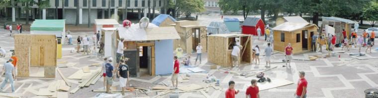 Organizers construct shacks on the Brickyard Sunday in preparation for Habitat for Humaniy&#8217;s Shack-a-thon. Organizations compete to raise money for building homes for the needy. Photo by Kevin Cook