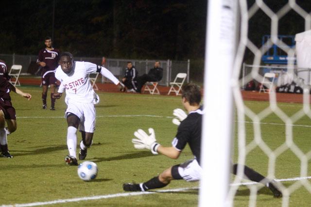 Redshirt senior forward Ronnie Bouemboue shoots the ball past Centenary goalkeeper Rennie Walker in the second half of Tuesday night&#8217;s game. Bouemboue had a goal and an assist in 60 minutes of play. The Pack beat the Gents 5-0. Photo by Brent Kitchen