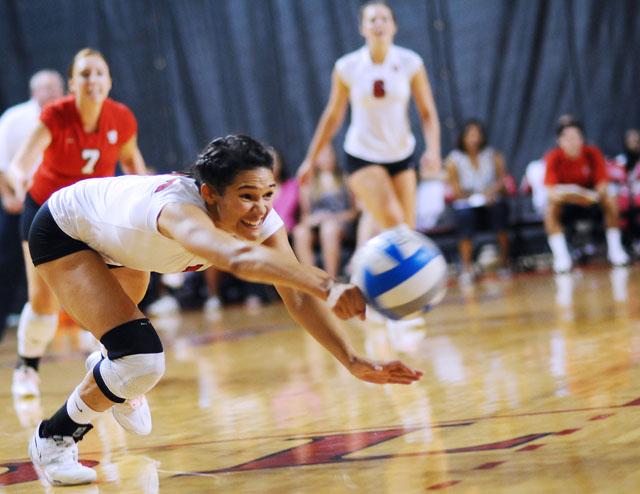 In Reynolds Coliseum, junior setter Alex Smith shows off her pink shoelaces as she dives for the ball during the match against Rugters on Sept. 11. Smith had 36 set assist during the five-set match. N.C. State lost to Rugters 3-2. Photo by Luis Zapata