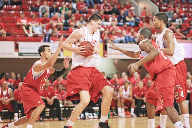 Junior guard Javier Gonzalez, redshirt senior guard Farnold Degand, and sophomore guard Julius Mays defend against freshman center Jordan Vandenberg during Red Ralley on Friday, Oct. 16. Mens played a scrimmage in the historical Reynolds Coliseum to deput this years team. Photo by Luis Zapata