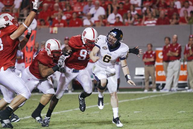 Graduate student defensive end Willie Young lunges at Murray St. quarterback Niko Yantko in an attempt to stop a pass. Young recorded two sacks for 14 yards and forced a fumble in a strong defensive showing by the Wolfpack at Carter-Finley Stadium. Photo by Nick Toptine