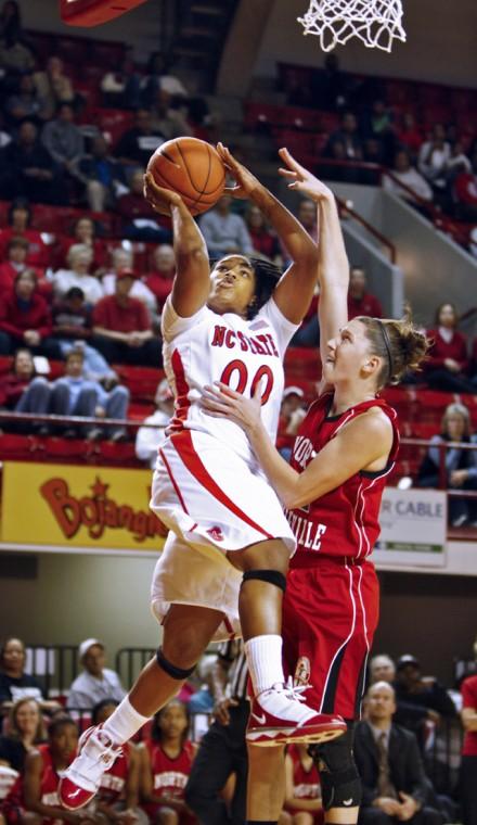 Amber White, redshirt junior guard, drives to the basket during the women's basketball scrimmage against North Greenville Monday in Reynolds Coliseum. White had 10 total points during the exhibition game. N.C. State won 87 to 44. Photo by Dreier Carr.