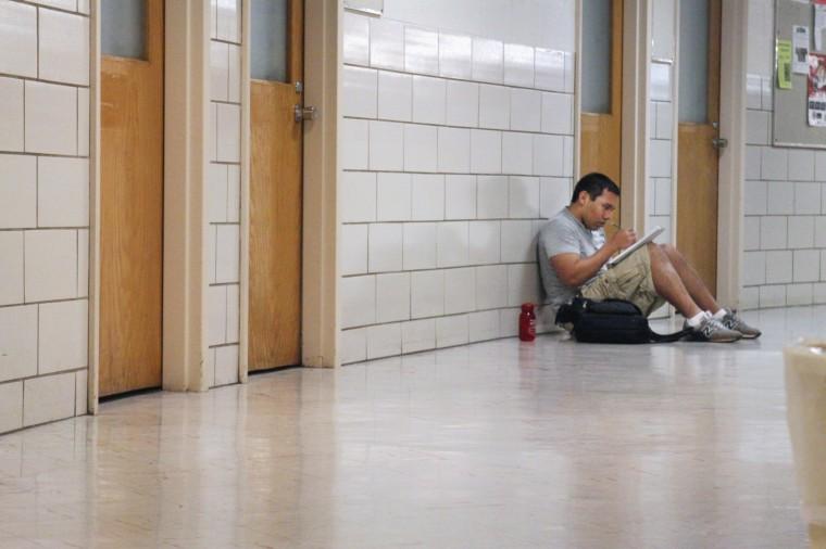 Sean Echevarria, a sophomore in mechanical engineering, takes a few minutes to do some work in the hallway of Harrelson Hall. "I don't like the steep steps. I don't like how you have to walk all the way around to go to the second or third floor," Echevarria said about the building. "I think it could have been designed a lot better." Photo by Marisa Akers