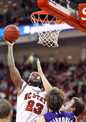 Tracy Smith attempts to dunk the ball during the second half of the game against Northwestern. Smith scored 23 points for the night but still could not pull the Wolfpack out of a 65-53 defeat to the Wildcats. Photo by Matt Moore