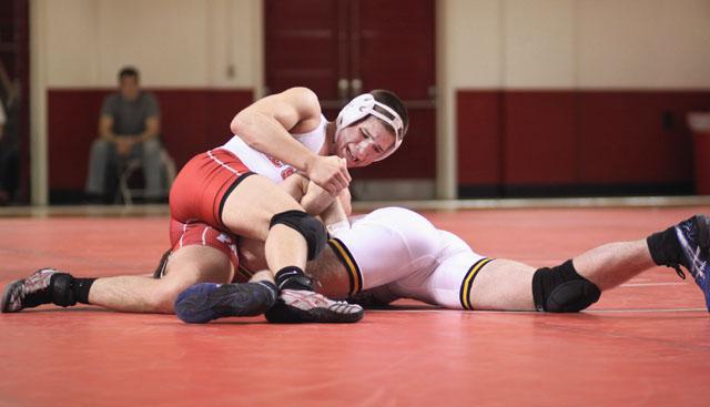 Brett Farina, sophomore wrestling at 157-pounds, works on top against Travis Sheehy of UNC-G at Reynolds Coliseum Wednesday. Farina won by major decision 15-7, bringing his career record to 8-10 and helping the Wolfpack to a 19-14 victory. Photo by Michael Shriver