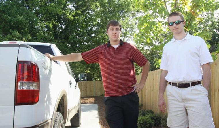 Ryan Walsh, owner of Capital City Groundskeeping LLC. and Daniel Walser, owner of YardScape Services Inc. work out of their trucks managing their respective landscaping companies, which operate in the Raleigh area. Walsh has seen increasing numbers in clientele, saying &#8220;even though we are in a bad economy, we already did double what we did last year.&#8221; Photo by Jose Tapia