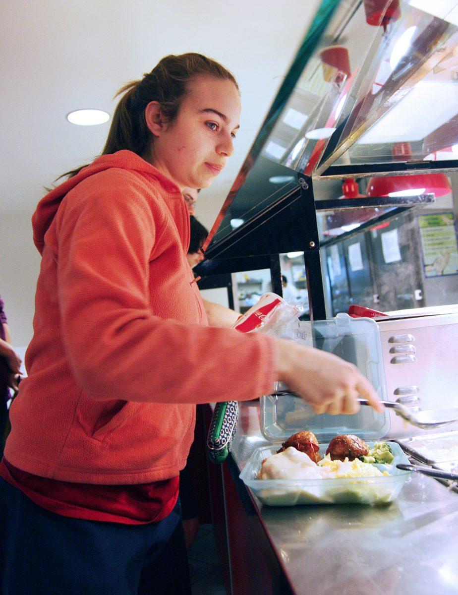 Brooke Griff, a sophomore in zoology, fills her tray to take it out from Clark Dining Hall Sunday at lunch. &#8220;It&#8217;s just easier. I can take it back to my room and eat while I&#8217;m working,&#8221; Griff said.