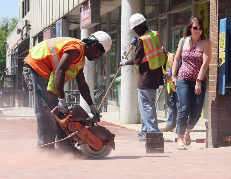 Kelly Price, a senior in psychology, tries to stay out of construction workers&#8217; way walking down Hillsborough Street Monday, April 12, 2010. &#8220;I&#8217;m more indifferent than most people. I don&#8217;t mind the noise or the walking&#8221;, Price said. &#8220;I take back roads and usually avoid Hillsborough. The road will be nice when it&#8217;s done.&#8221;