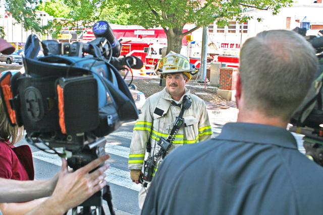 Battalion Chief Rob Johnson explains Thursday's Hillsborough Street gas leak to reporters. D.H. Hill library was one of the many buildings evacuated during the emergency. Photo by Bryant Robbins