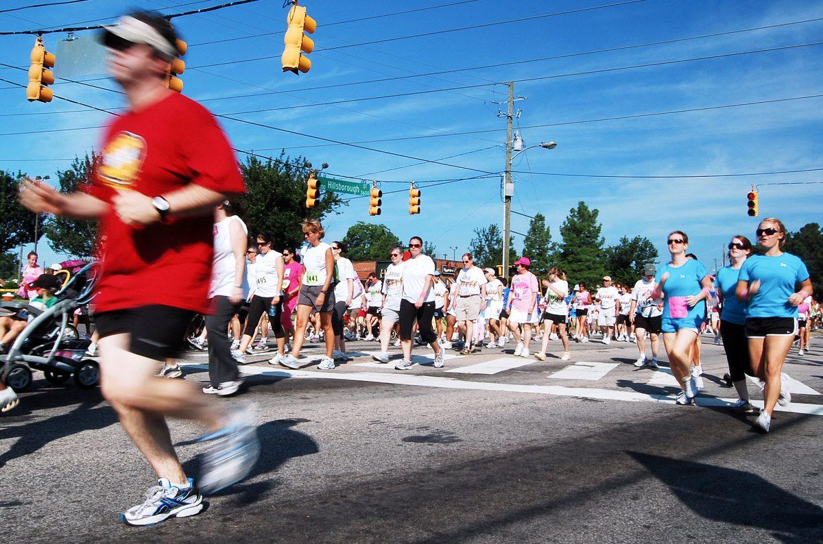 Runners and walkers in the 5K open run event at the 2009 Susan G. Komen Race for the Cure run through the intersection of Hillsborough and Gorman/Faircloth streets Saturday.