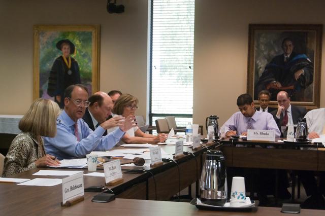 UNC System President Erskine Bowles talks to other BOG meeting attendees about the various tuition hikes proposed by each UNC System school.