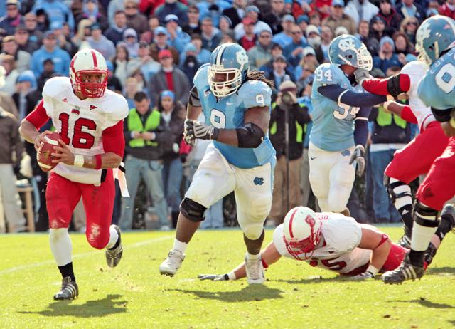 Russell Wilson, a redshirt freshman quarterback, scrambles to get the ball away from UNC's defensive tackle Marvin Austin during the game at Kenan Stadium in Chapel Hill, N.C., on Saturday , Nov. 22, 2008. The NCAA is investigating Austin for policy violations.