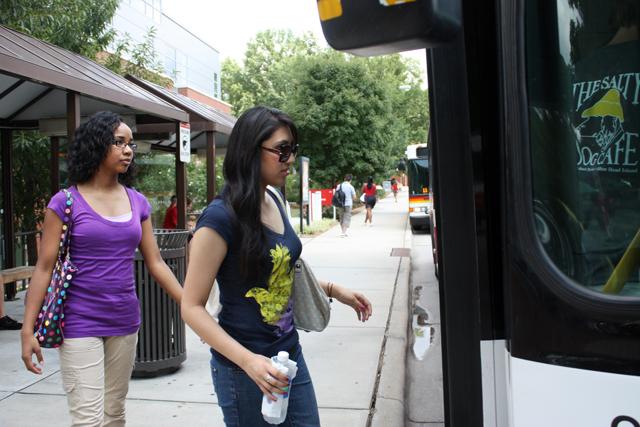 Sana Khan, a sophomore in biological sciences, and Kimberly Rucker, a freshman in zoology, board a Wolfline bus at the Carmichael Gym bus stop on Tuesday, Aug. 17.