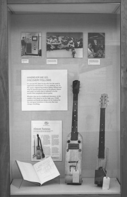 The two string instruments shown are two of the world's first electric guitars. Located in an exhibit on the West wing of the 2nd floor of D.H. Hill library, these two models were a product of 2 years of collaboration between PAMS and the Special Collection Research Agency. Photo by Lee Daniello