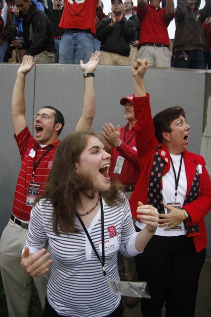 Celebrating in rapture after a N.C. State touchdown, David Bulfin, senior industrial design, Pat Bulfin, freshman animal science, Bill Bulfin, and Susan Bulfin cheer after watching a touchdown from feet away in Carter-Finley Stadium Saturday Sept. 26, 2009. "They love [State] because my brother and I do&#8211; and such support, such trust, is a precious gift from the ones I love," Pat Bulfin said in her essay which won the Family of the Year contest.
