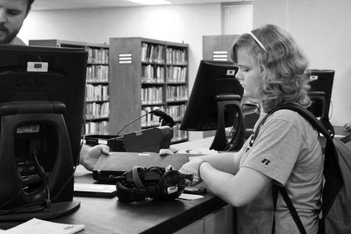 Kim Dennis, a freshman in First Year College, gets help with a laptop she checked out in D.H. Hill Library. &#8220;I checked out a movie I have to watch for class. For some reason, PC&#8217;s don&#8217;t play the foreign movies,&#8221; Dennis said as she switched it out for a Mac. &#8220;The people here are really helpful. I think this is a good [resource] for students.&#8221; Photo by Marisa Akers
