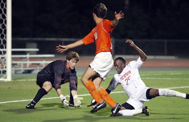 Trying to score against Virginia Tech&#8217;s goalkeeper, Akil DeFreitas, a senior in African studies, falls to the ground with the ball inches away from scoring. State played a fierce game against the Hokies, having the game tied at half time. But Viriginia Tech took pulled away in the last few minutes of the second half on Saturday, Sept. 25. Photo by Danielle Neujahr.