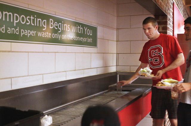 Sean Maroni, a freshman in engineering, helps the campus-wide Go Green movement by composting his food and paper waste at Fountain Dining Hall on Thursday.