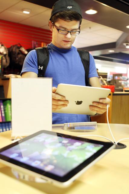 Connor Hovis, a freshman in First Year College, plays a racing game on an iPad in the University Bookstore. "I've never played on an iPad before but now I kinda want one so I can play games and check my e-mail," Hovis said.