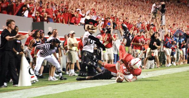 Freshman running back Mustafa Greene dives into the end zone to score a touchdown during the Thursday night game against Cincinnati. Greene had 16 runs during the game for 84 yards. N.C. State won the contest 30-19. Photo by Luis Zapata
