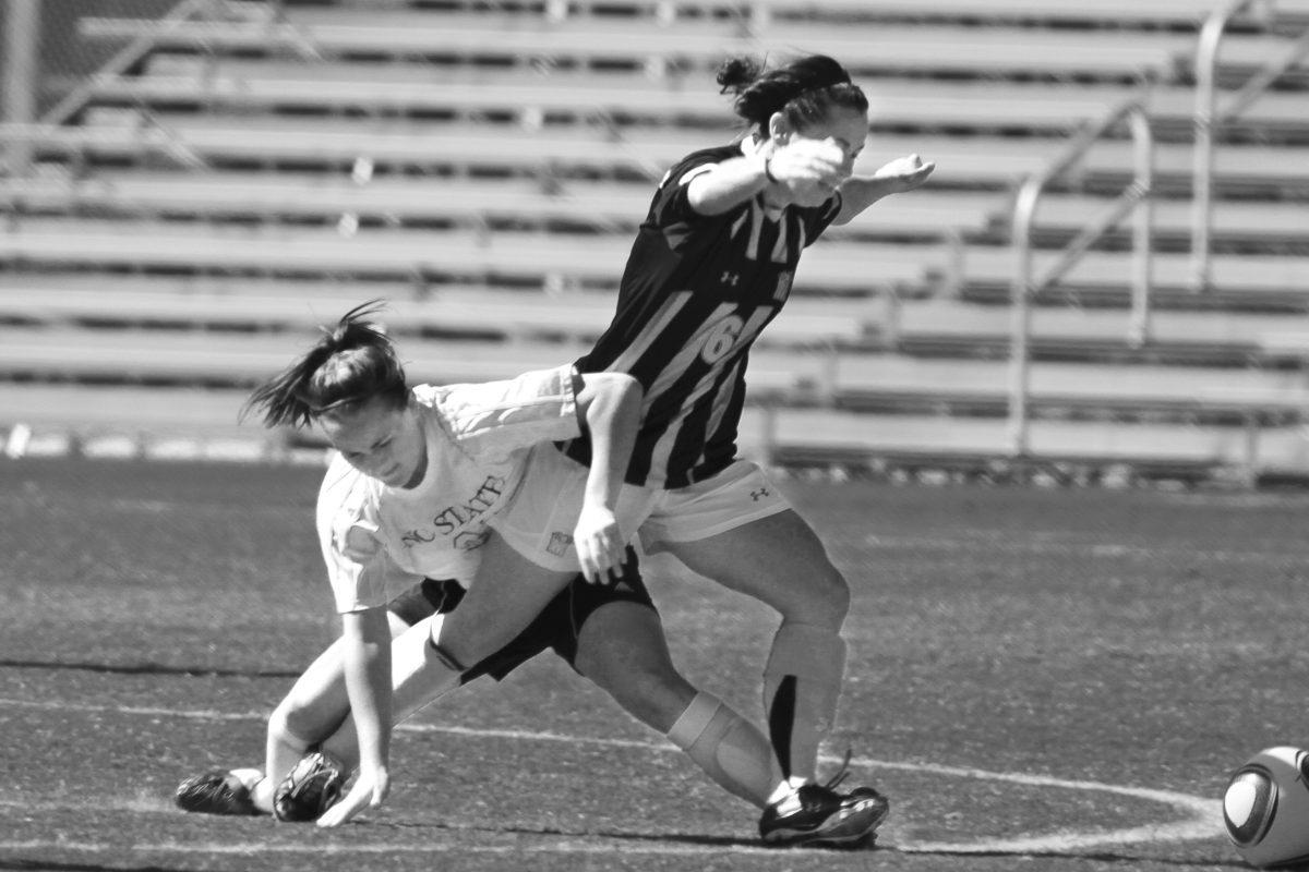 Freshman Midfielder Ariela Schreibeis fights a Maryland player for the ball during the first half of the NC State vs. Maryland Women&#8217;s Soccer game on Dail Field on Sunday.