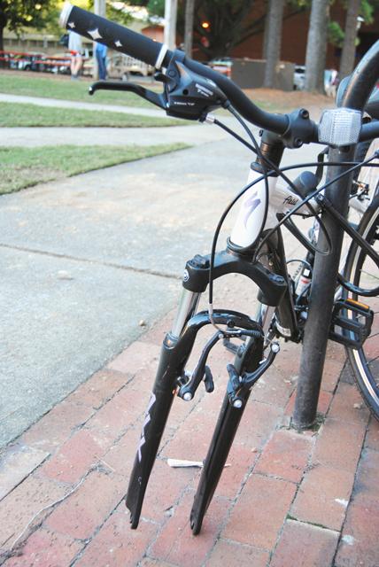 Outside of Turlington hall, a bike with a stolen wheel is abandoned. bike theft is one of the most common crimes on campus and students are encouraged to keep locks on easily stolen parts such as wheels and seats.